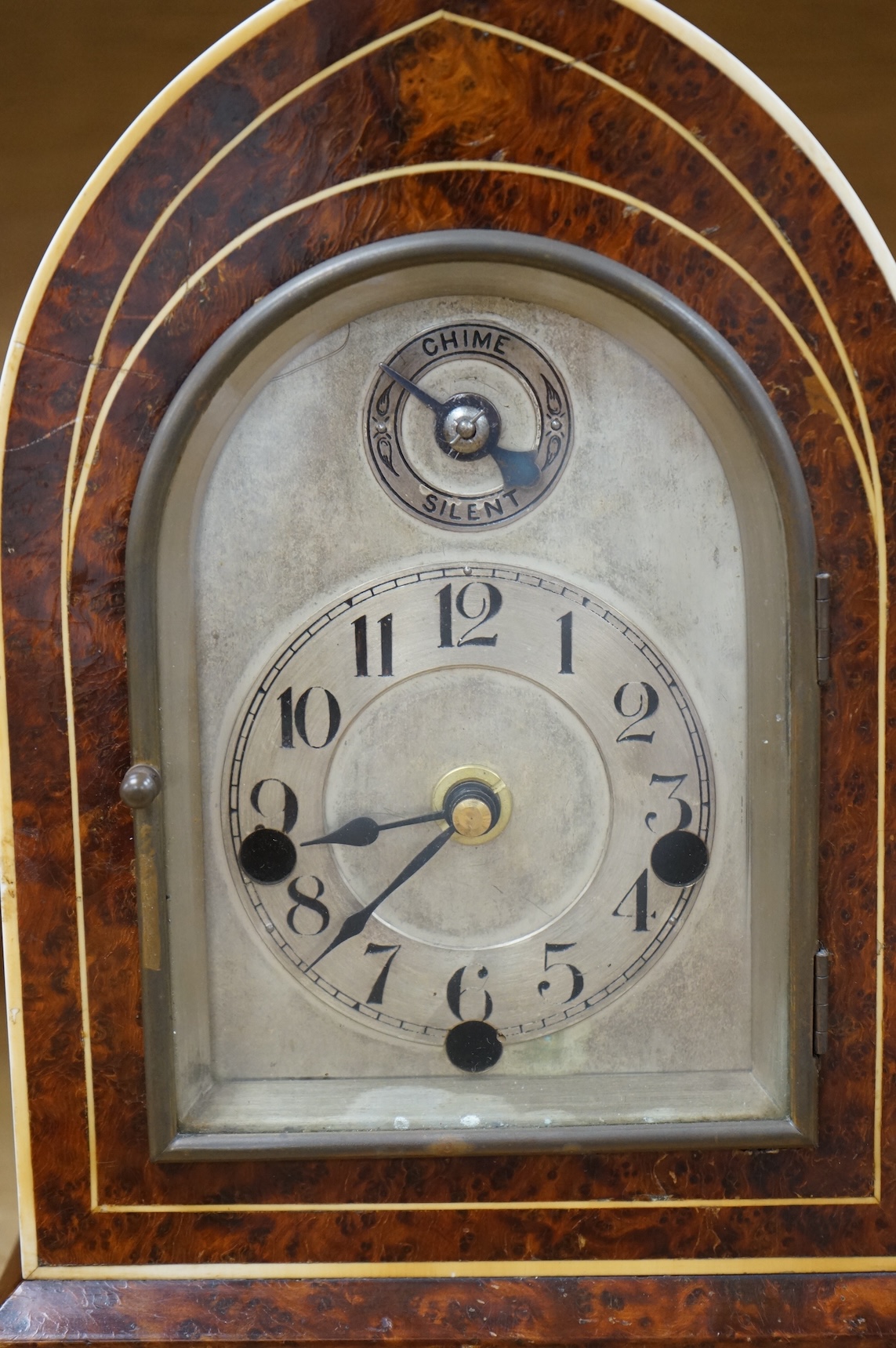 An early 20th century French eight day Amboyna mantel clock, with Holly and ivory stringing, retailed by Charles Frodsham, 25cm high CITES Submission reference 3SPE5K23